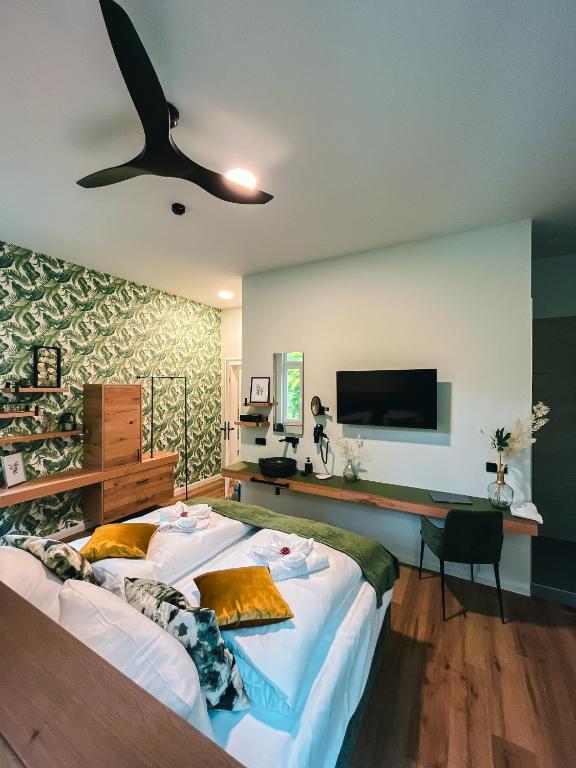a bedroom with a large bed and a flat screen tv at Gasthof Schloss Hubertus in Erfurt