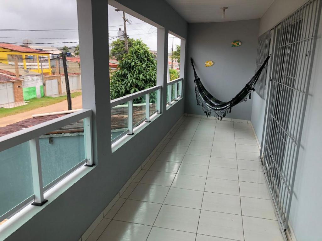 a hallway with windows and a hammock in a house at Casa de Praia - Carneiros, Tamandare, Pernambuco in Tamandaré
