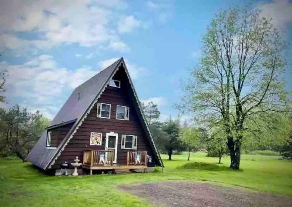 a large wooden house with a gambrel roof at U.P Norse A-frame close to Powderhorn Ski Resort in Ironwood