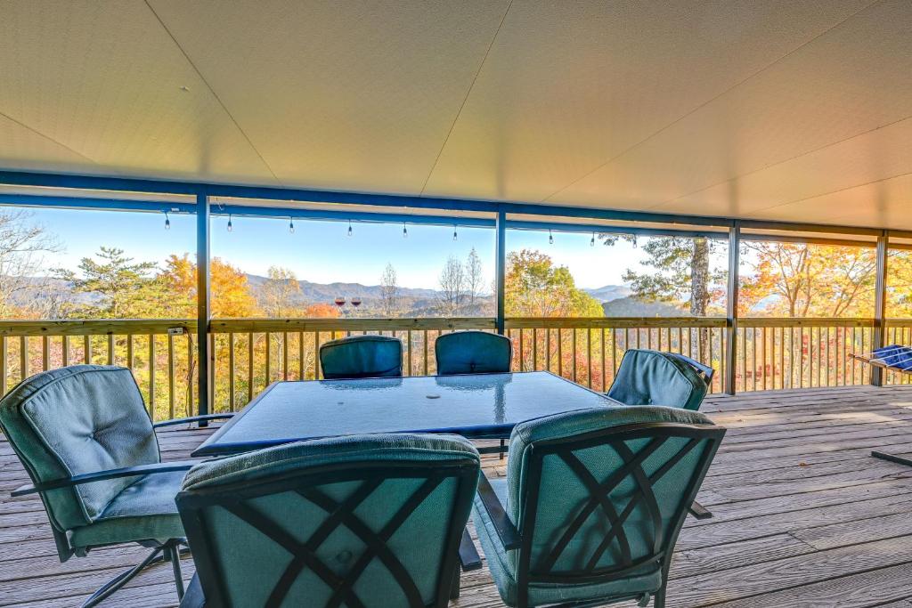 a table and chairs on a deck with a view at Stunning Franklin Cabin with Deck and Mountain Views in Franklin