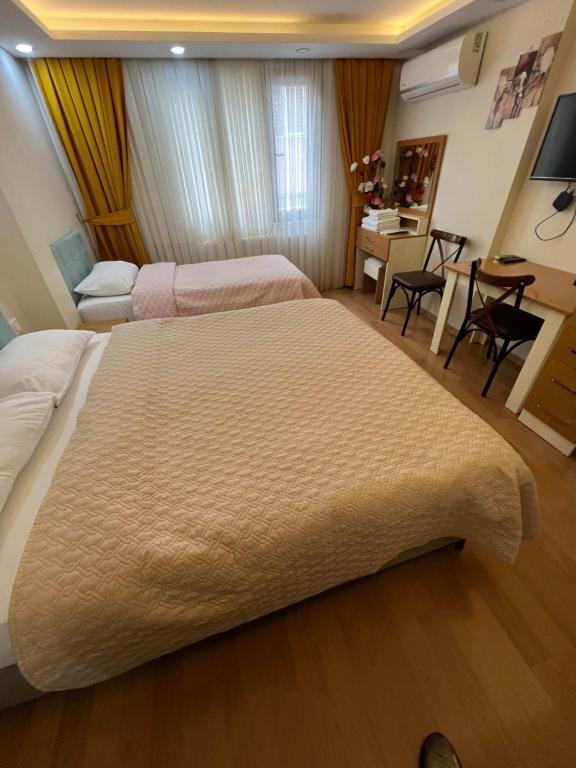 a hotel room with two beds and a desk at Hagia sophia studios in Istanbul