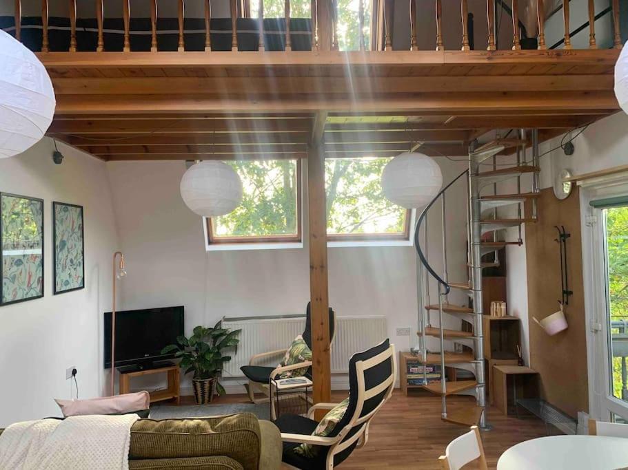 a living room with a loft bed and a couch at The Studio in Beeston