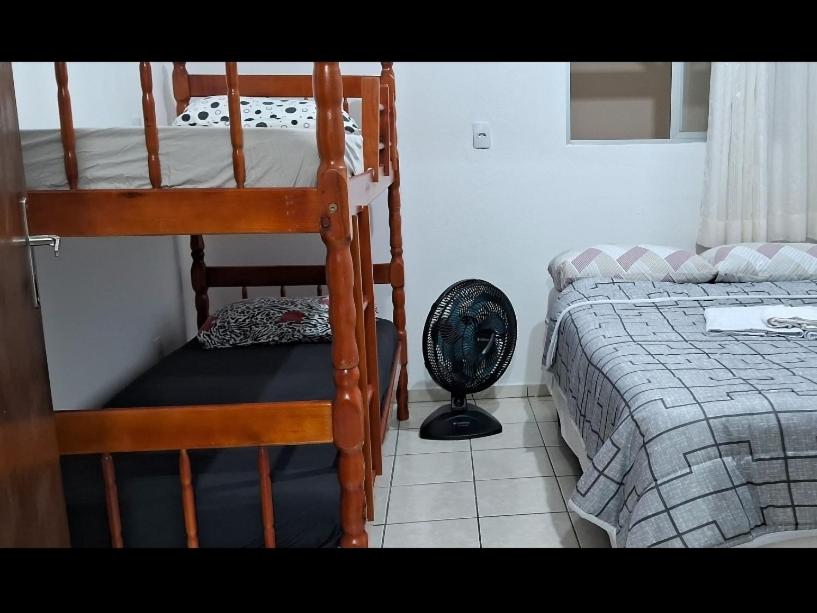 a bedroom with two bunk beds and a fan at AP número 3 in Governador Celso Ramos
