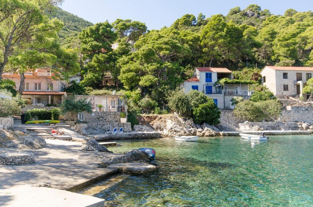 a view of a river in a town with houses at Apartments and Rooms Nike in Sobra