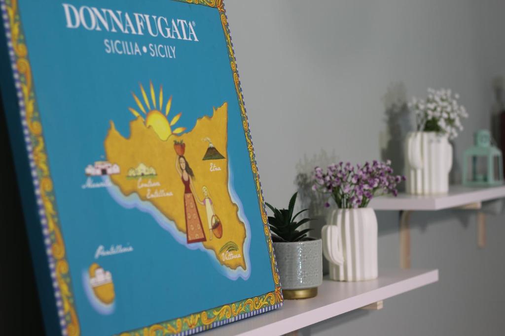 a poster of a map of dominica on a shelf at A' Nica room in Palermo