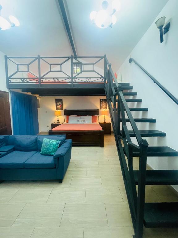 a living room with a bunk bed and a staircase at Cabañas Marroquin 1 in Copán Ruinas