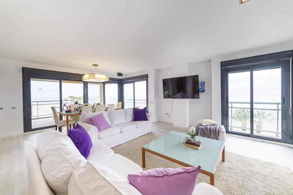 a living room with a white couch and purple pillows at Fantastic penthouse 270m2 with amazing sea views in Roquetas de Mar