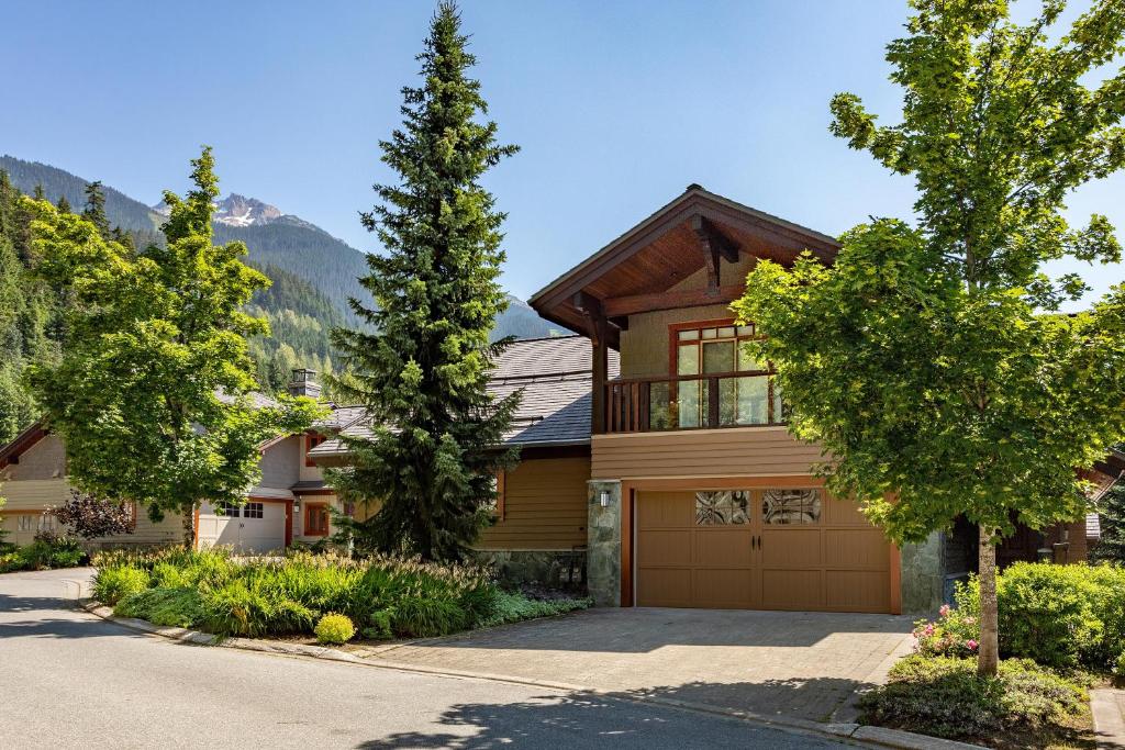 a house in the mountains with a garage at Taluswood The Lookout 5 - Secluded Chalet with Hot Tub & Incredible Views - Whistler Platinum in Whistler