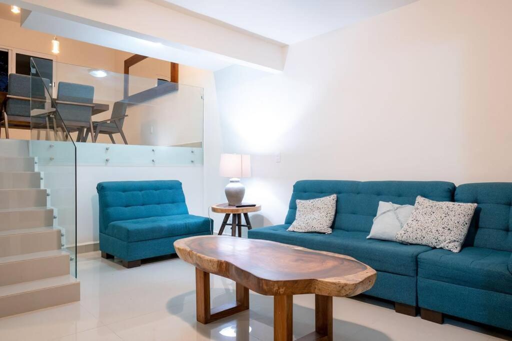 a living room with a blue couch and a table at Luxury and Comfort in the heart of Vallarta in Puerto Vallarta
