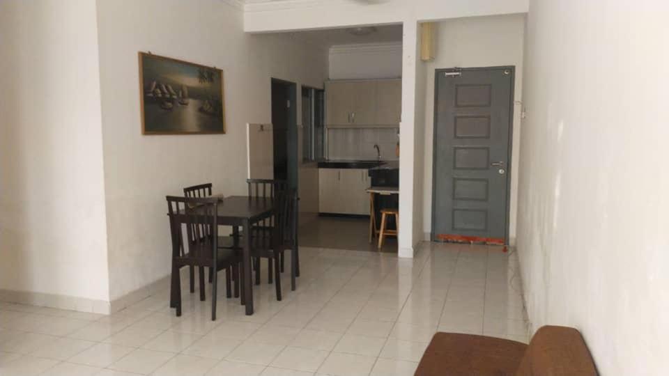 a kitchen and dining room with a table and chairs at RIZQI HOMESTAY PRIMA PRESINT 11 PUTRAJAYA in Putrajaya