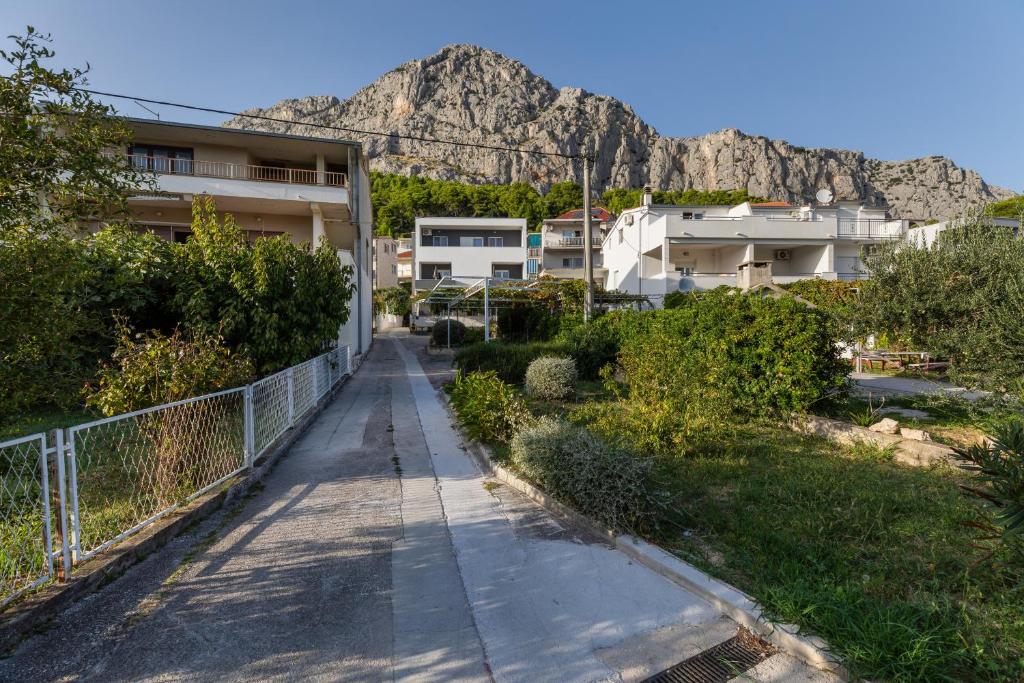 a walking path with a mountain in the background at Apartments with a parking space Omis - 2745 in Omiš