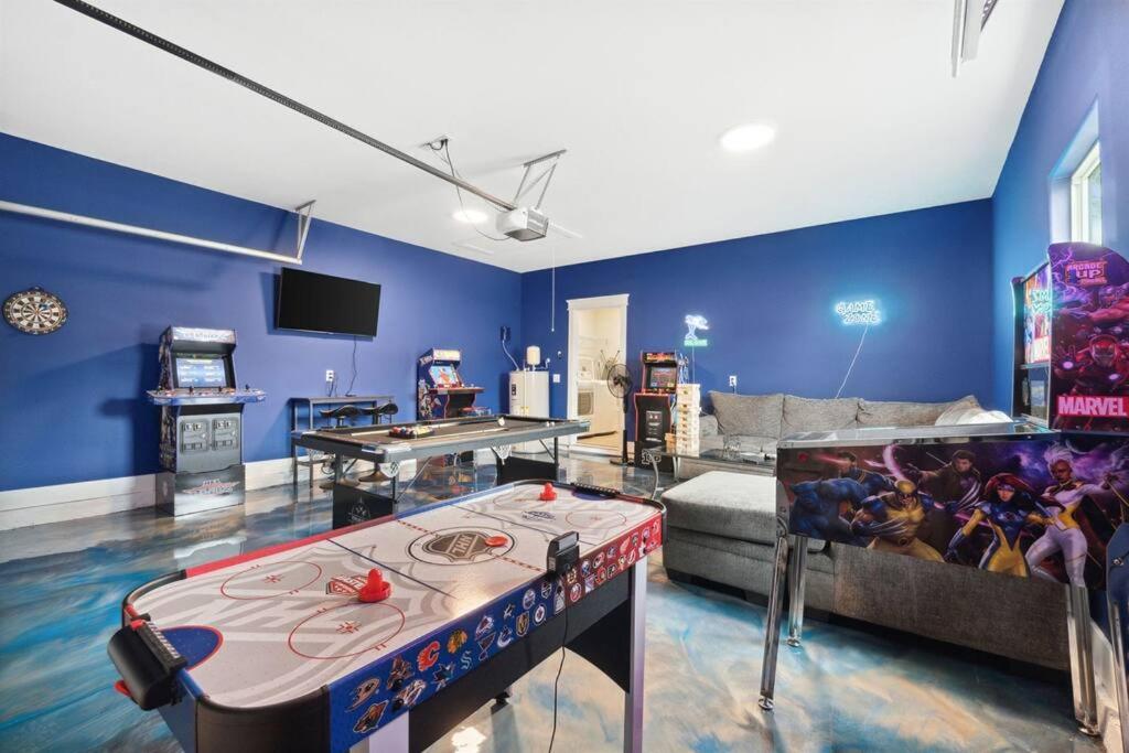 a living room with a ping pong table in the middle at Laguna Beach House with a Game Room in Panama City Beach