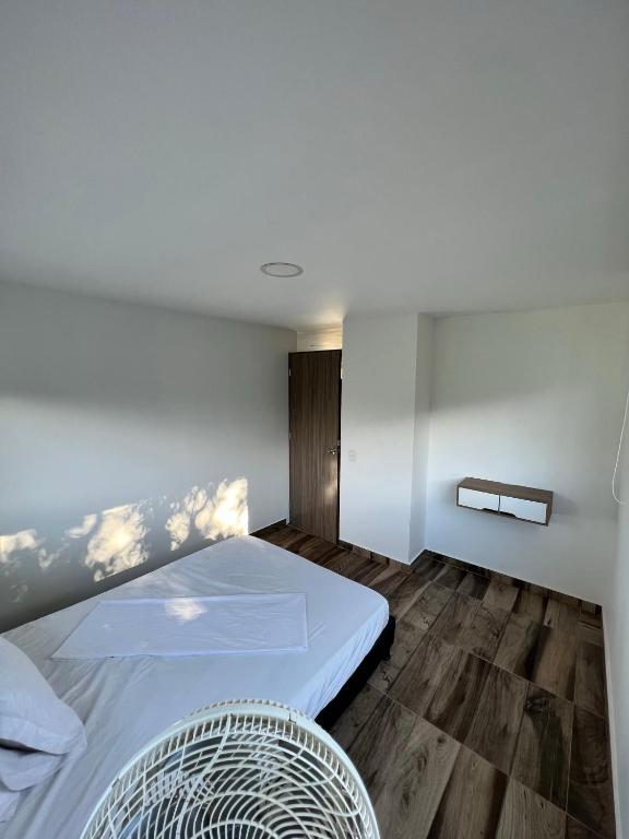 a bedroom with a bed and a wooden floor at poblado canela in Melgar