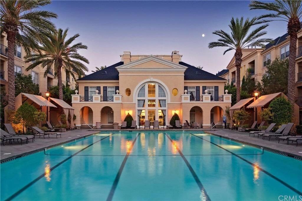 a large swimming pool in front of a building at Luxury condo near Irvine Business & UCI Hospital in Irvine