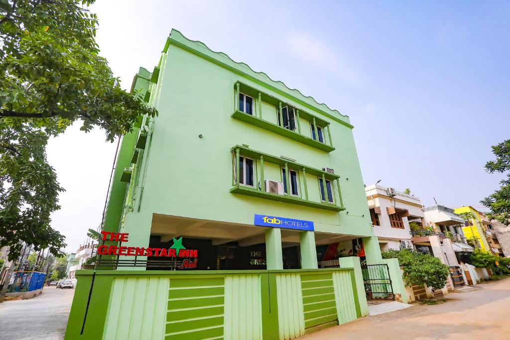 um edifício verde com um sinal em frente em FabHotel Greenstar Inn em Bhubaneshwar