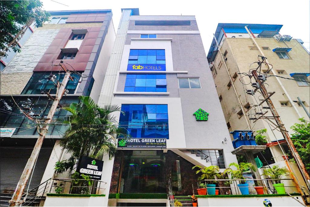 a building with a sign on the front of it at FabHotel The Green Leaf in Kondapur