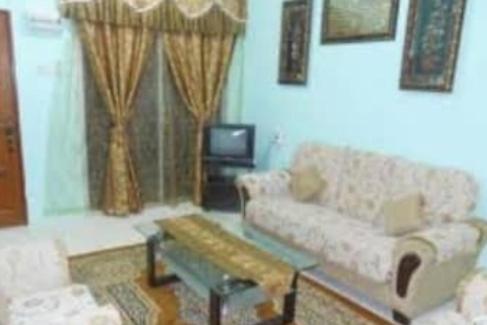 a living room with a couch and a tv at DENAR HOMESTAY CHANGLUN KEDAH in Changlun