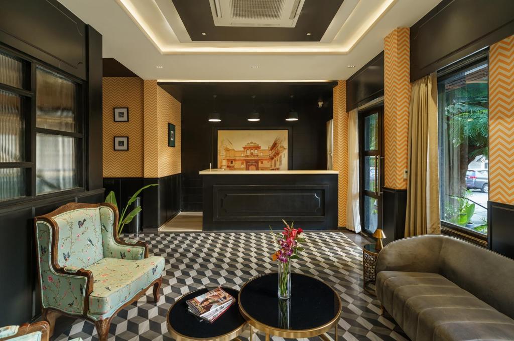 a living room with a couch and a table at City Connect by Downtown Udaipur in Udaipur