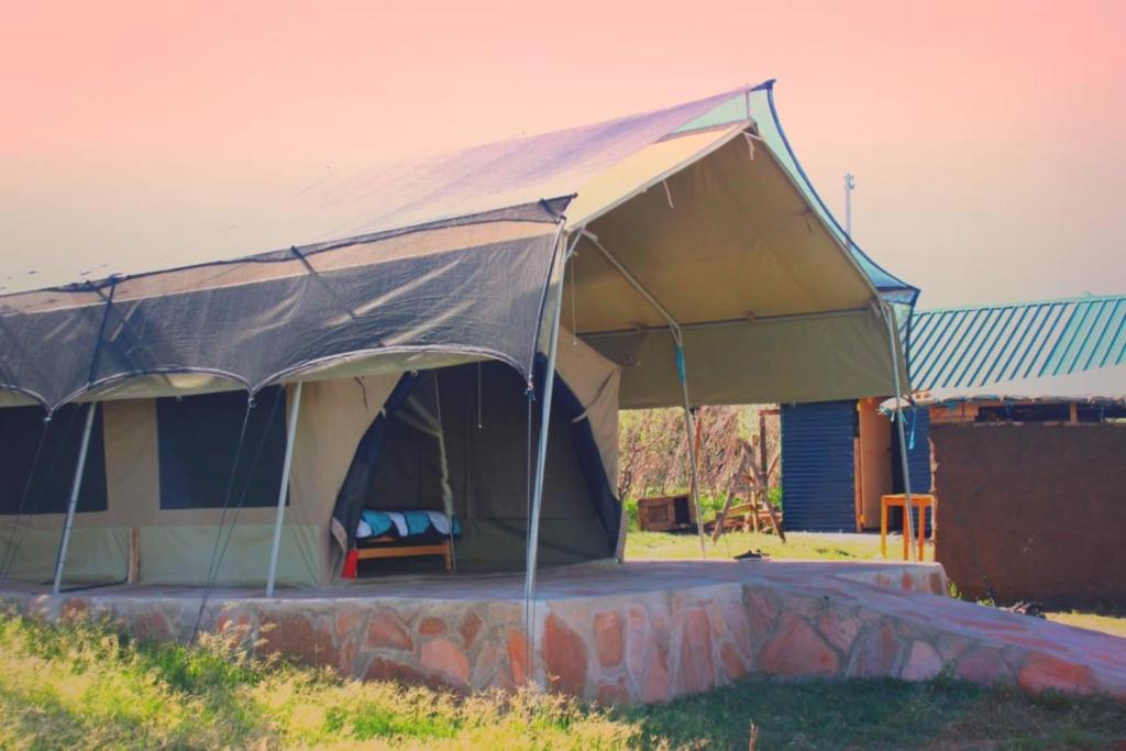 a tent is set up in a yard at leruk Maasai safari camp in Sekenani