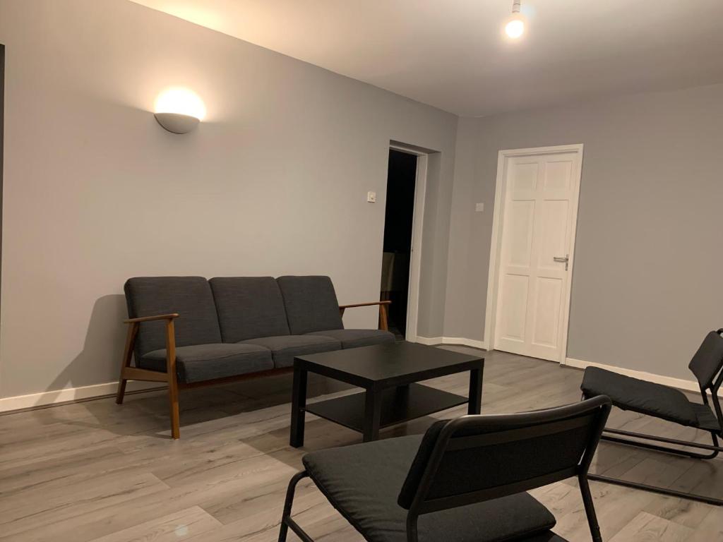 a living room with a couch and a table at Modern Room Close to Warwick University in Canley