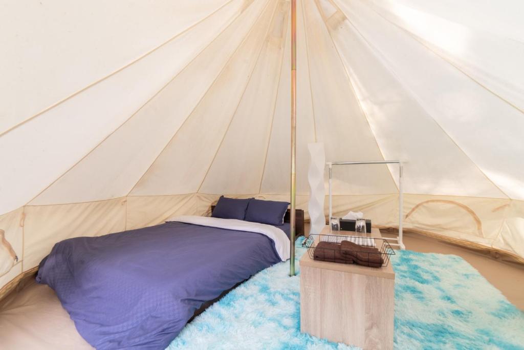 a bedroom with a bed in a tent at Glamchette Okayama -Glamping & Auto Camp- - Vacation STAY 44575v in Mimasaka