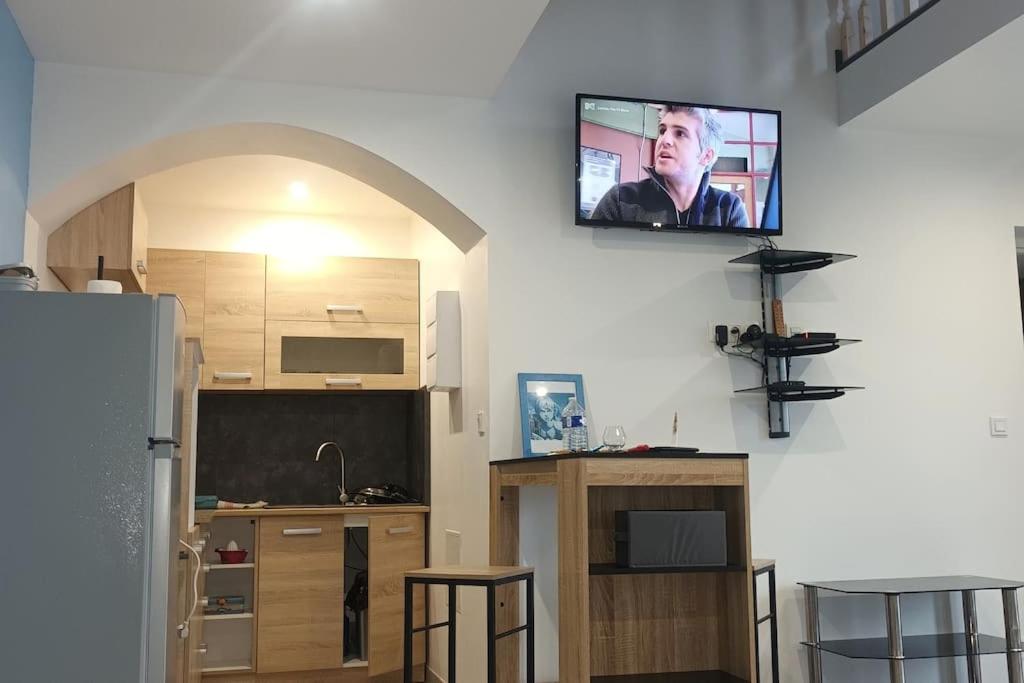 a living room with a tv on the wall at Nouveau Loft T2, connecté internet fibre et wifi in Saint-Quentin