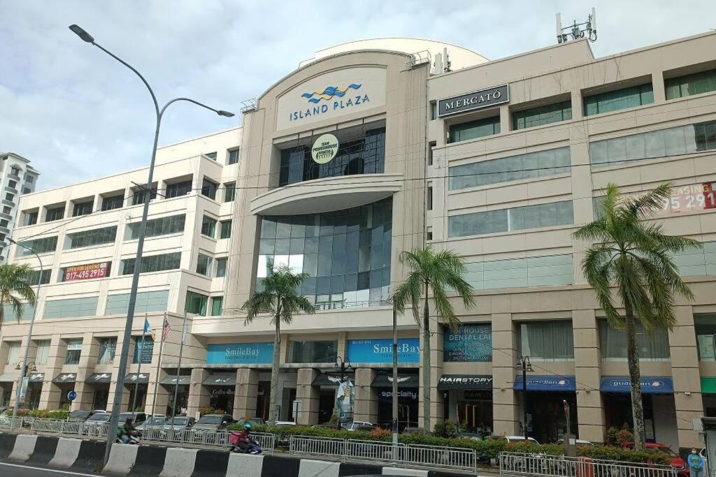 a large building with a clock on the front of it at 118 Apartment Tanjung Tokong by Yen's Sojourn in George Town