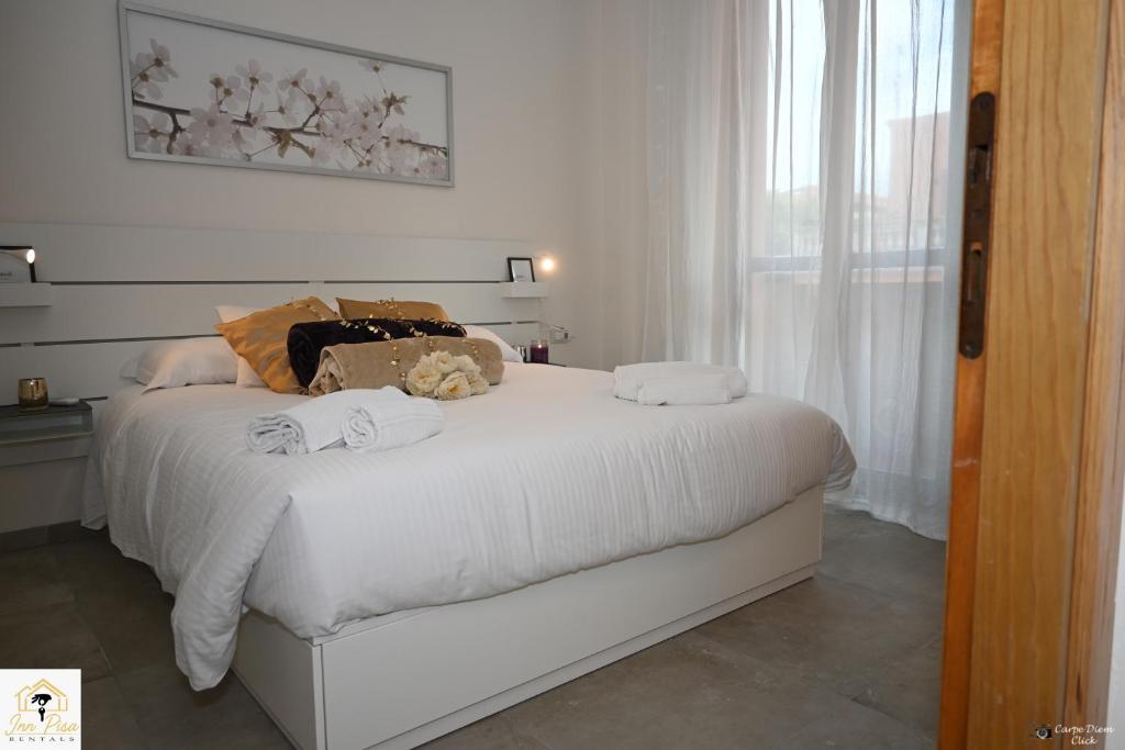 Ένα ή περισσότερα κρεβάτια σε δωμάτιο στο Inn Pisa Rentals - Downtown Cozy Apartment