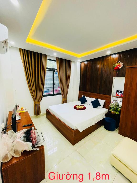 a bedroom with a bed and a desk in a room at Sapphire HOTEL HUE in Hue