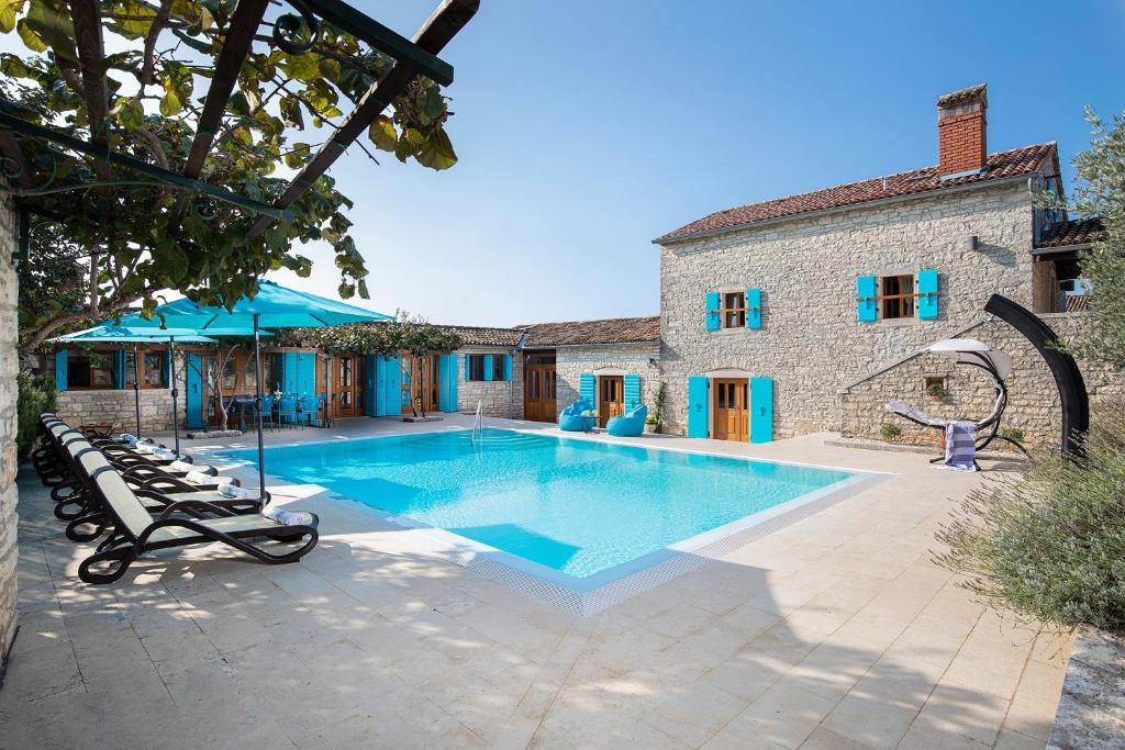 a swimming pool in front of a house at Villa Azzurra in Kanfanar