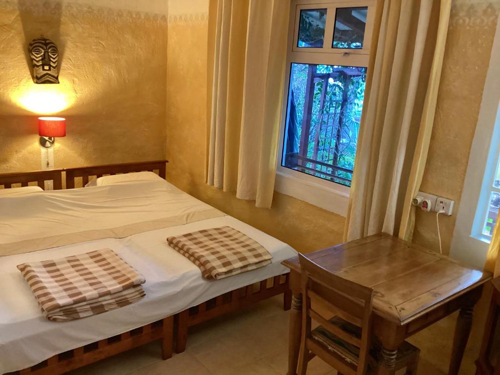 Postel nebo postele na pokoji v ubytování La Reine Creole
