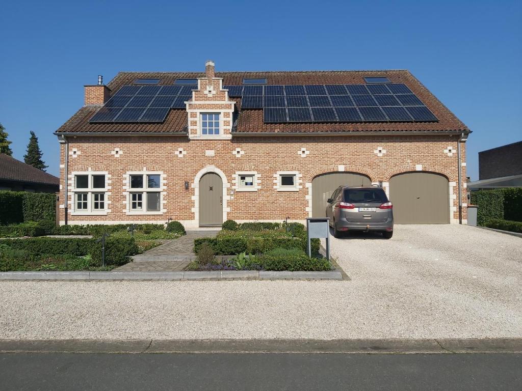 uma casa com painéis solares no telhado em B&B Asmara em Maasmechelen