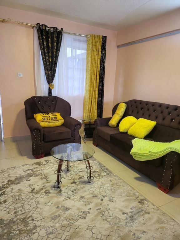 a living room with a couch and a coffee table at G&G Executive Homes Pipeline Nakuru in Nakuru