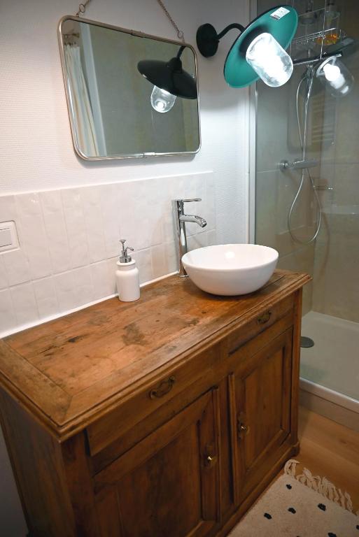 a bathroom with a sink and a mirror at La Brocante - Meilleurhote-Brioude in Brioude