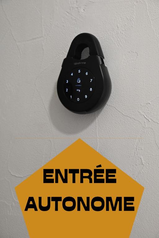 a black phone on a wall with an office entrance sign at La Brocante - Meilleurhote-Brioude in Brioude
