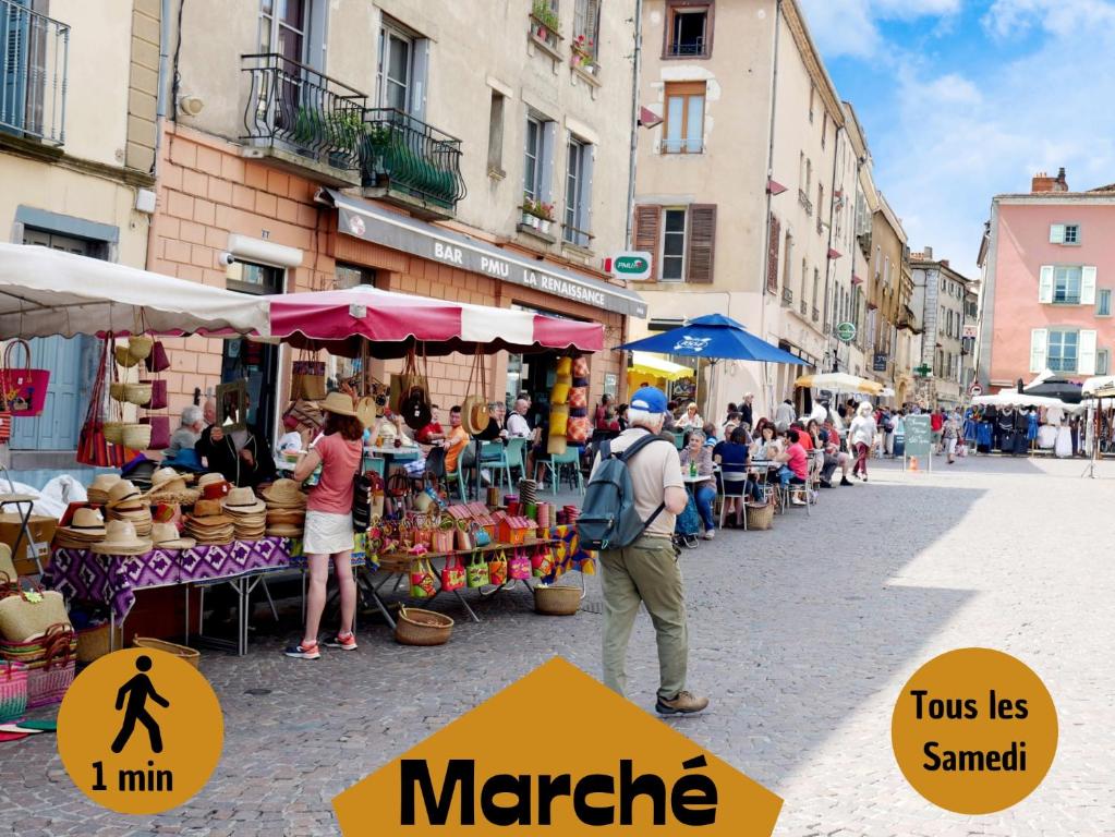 a group of people standing at an outdoor market at La Brocante - Meilleurhote-Brioude in Brioude