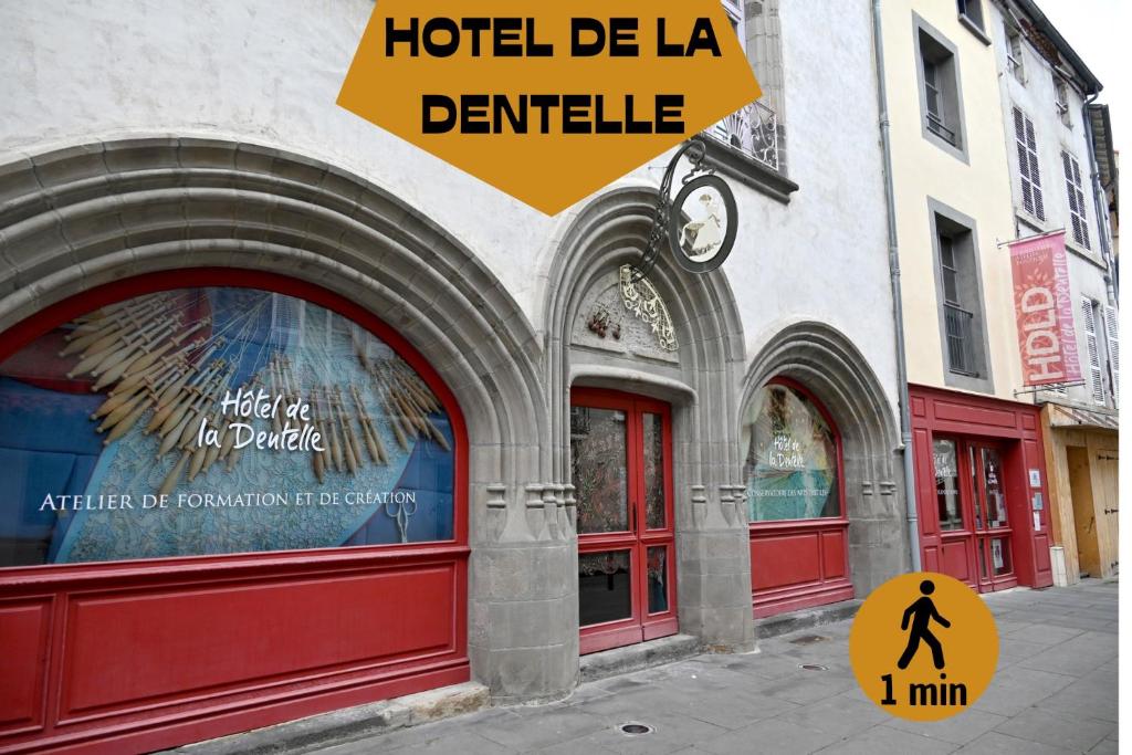 a facade of a building with red doors at La Brocante - Meilleurhote-Brioude in Brioude