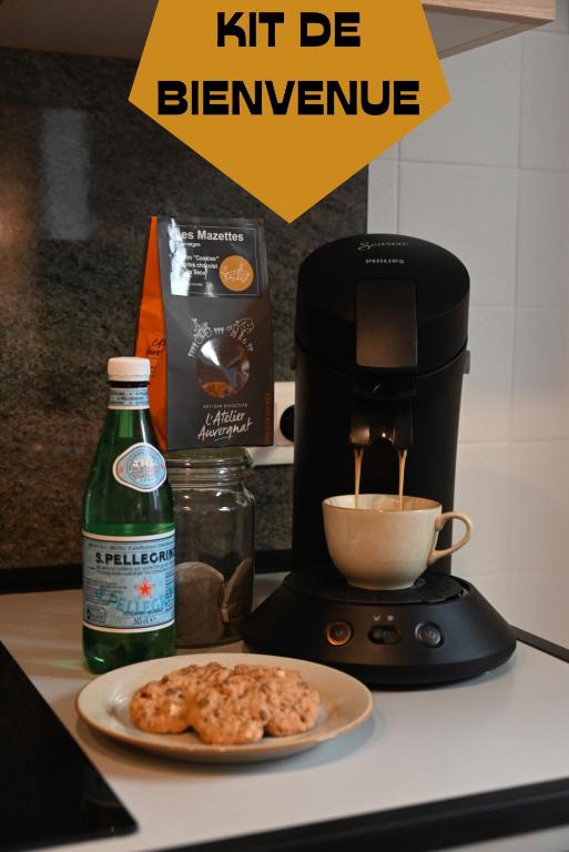 a coffee maker and a plate of food on a counter at La Brocante - Meilleurhote-Brioude in Brioude