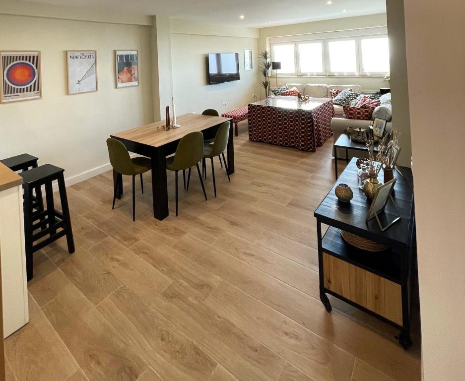 a living room with a table and a couch at Luxury and newly refurbished 3 bedroom apartment next to the slopes including indoor parking in Sierra Nevada