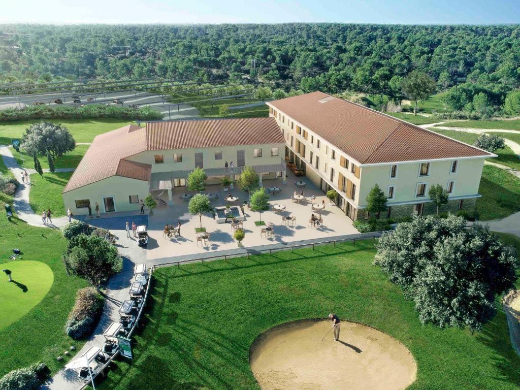 an aerial view of a building with a golf course at ibis Styles Cabriès Aix-en-Provence TGV in Cabriès