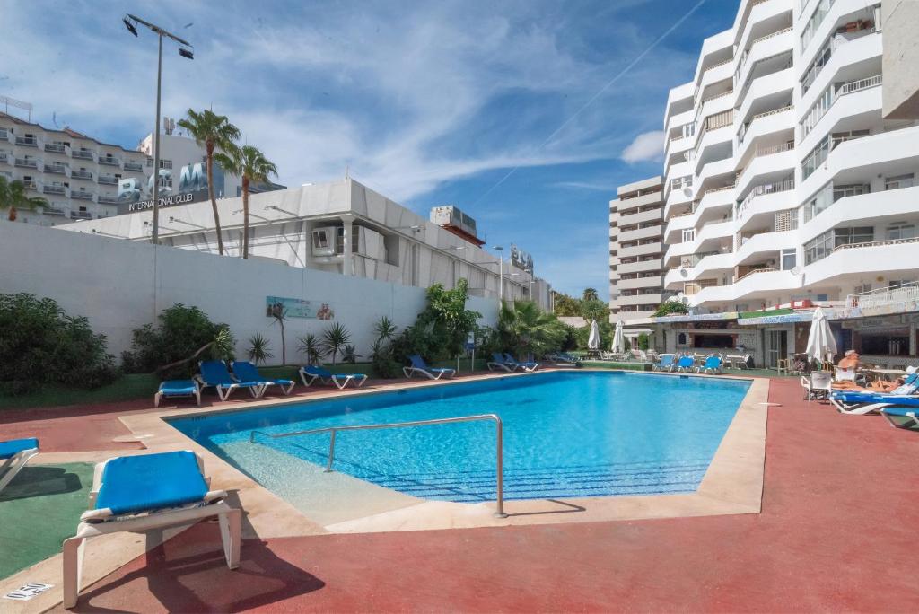a swimming pool in the middle of a building at Magalluf Playa Apartments - Adults Only in Magaluf