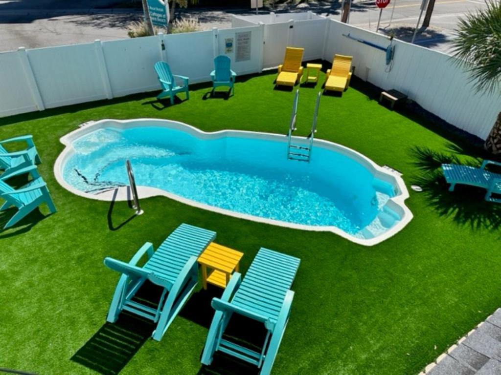a swimming pool with chairs and a swing at C7-Dolphin in St Pete Beach