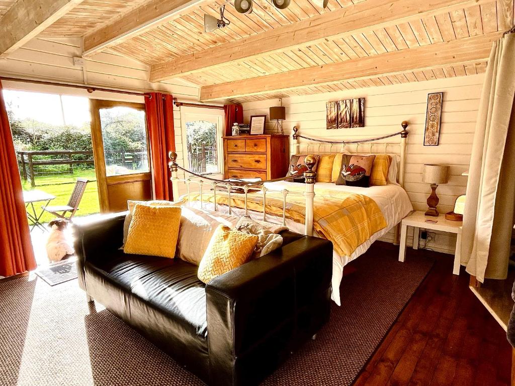 una camera con letto e divano di Primrose Cabin a Dorchester