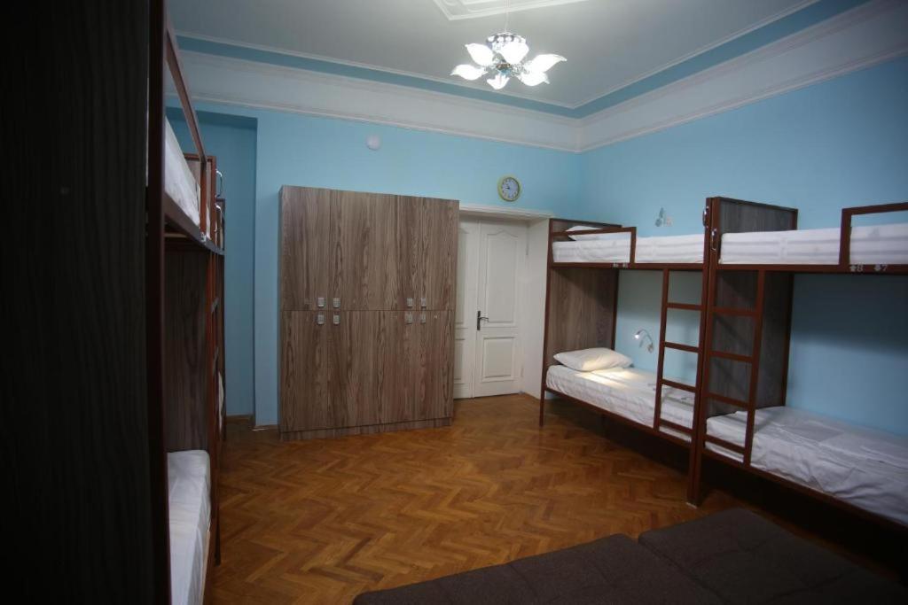 a room with two bunk beds and a hallway at Hostello in Baku