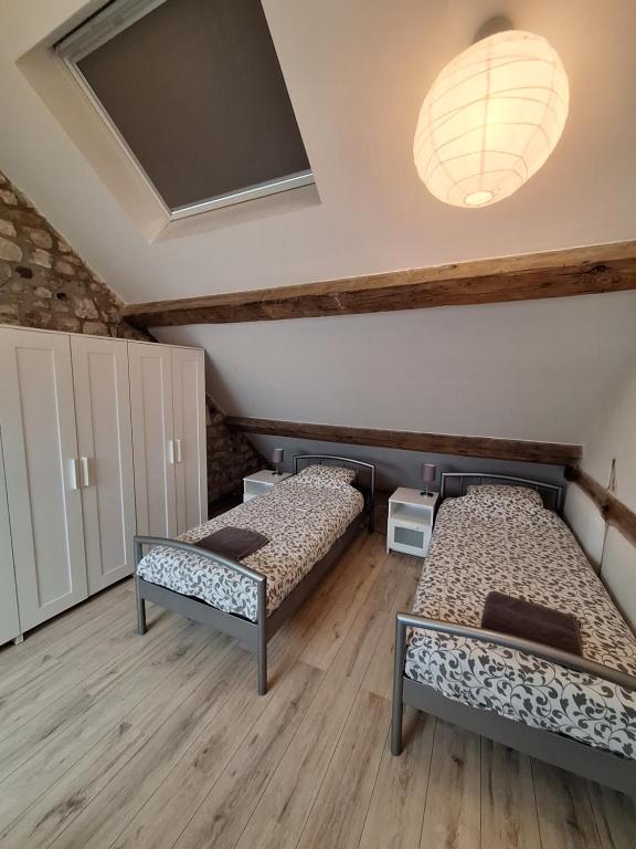 Postel nebo postele na pokoji v ubytování Gîte Cour Delhez