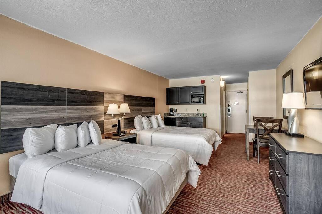 a hotel room with two beds and a kitchen at Renovated Condo at Landmark Resort, Waterpark View in Myrtle Beach