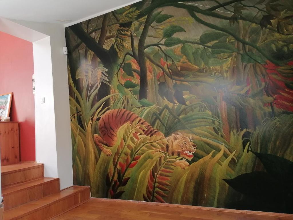 a mural on the wall of a staircase with a tiger in a forest at Loft en duplex 270 m2 &amp; Jardin patio terrasse sauna in Chaville