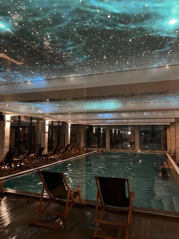 a swimming pool with a starry ceiling in a building at Milmari Apartman N92 Kopaonik in Kopaonik