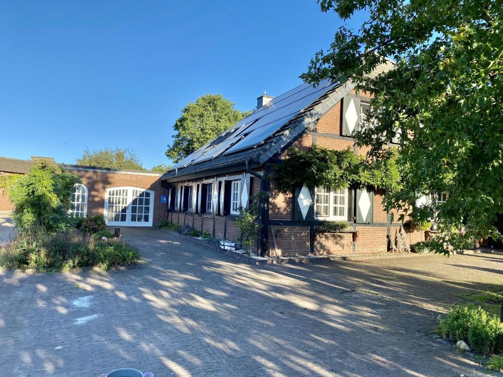 a brick building with a driveway in front of it at Sittermansweg in Geldern