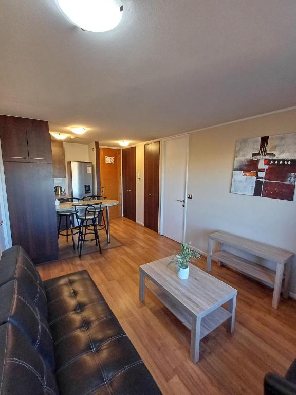 a living room with a couch and a table at Departamento Central en Calama in Calama